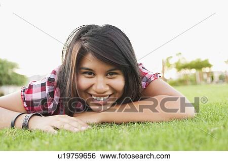Young smiling woman looking at camera View Large Photo Image Stock Photograph - Young smiling woman looking at camera. Fotosearch