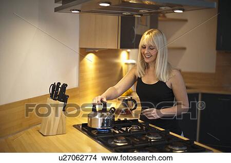 Young woman in kitchen View Large Photo Image Picture - Young woman in kitchen. Fotosearch