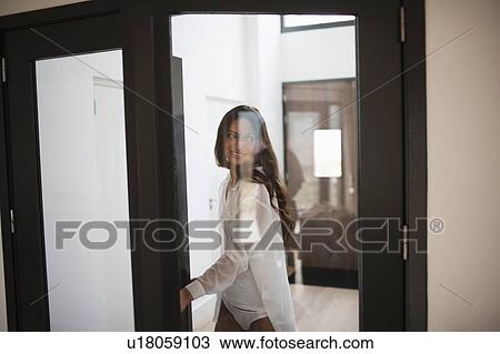 Young woman opening door View Large Photo Image Stock Image - Young woman opening door. Fotosearch
