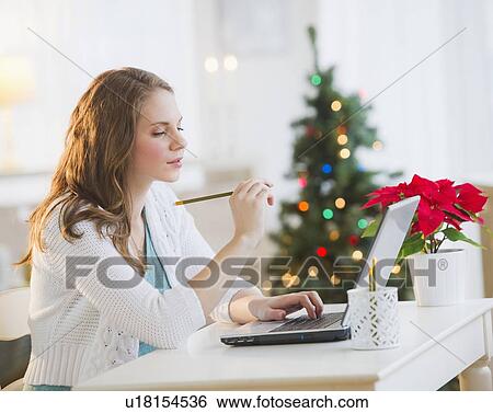 Young woman reading gift list for Christmas View Large Photo Image Stock Photograph - Young woman reading gift list for Christmas. Fotosearch