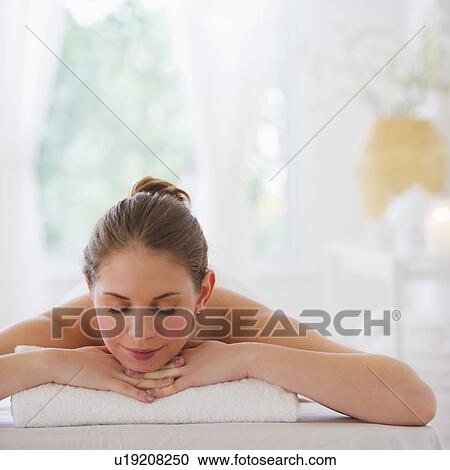 Stock Image - Young woman relaxing in beauty spa. Fotosearch