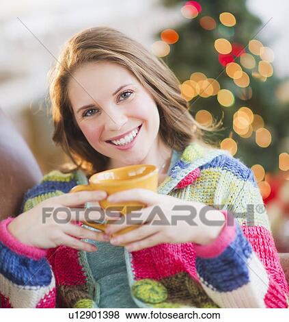 Young woman relaxing with hot drink View Large Photo Image Stock Photo - Young woman relaxing with hot drink. Fotosearch