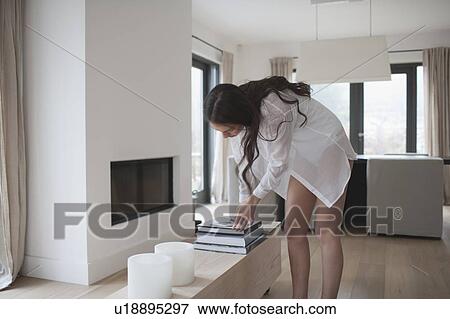Young woman searching through books View Large Photo Image Stock Photo - Young woman searching through books. Fotosearch