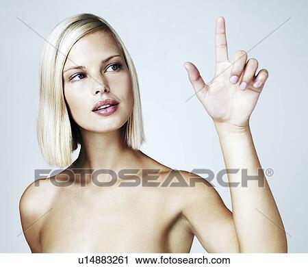Young woman touching screen, studio shot View Large Photo Image Stock Image - Young woman touching screen, studio shot. Fotosearch
