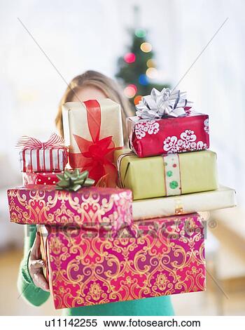 Young woman with stack of colorful Christmas gifts View Large Photo Image Stock Photography - Young woman with stack of colorful Christmas gifts. Fotosearch