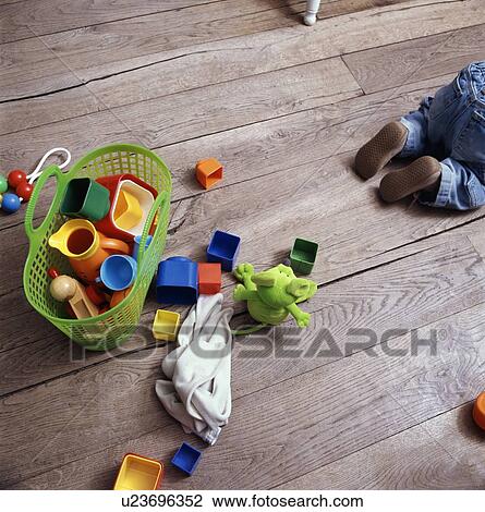 Stock Image - Babys toys on wooden floor. Fotosearch