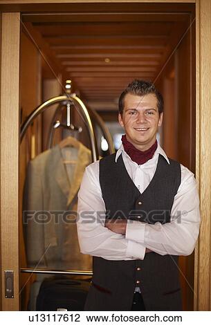 Bellhop smiling with luggage View Large Photo Image Stock Image - Bellhop smiling with luggage. Fotosearch