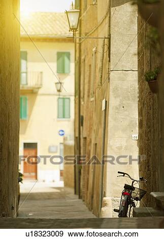 Stock Photo - Bicycle parked in village alleyway. Fotosearch