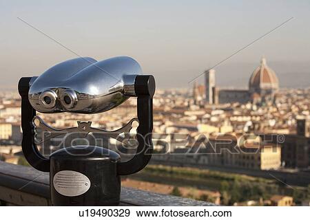 Stock Photo - Binoculars overlooking cityscape. Fotosearch
