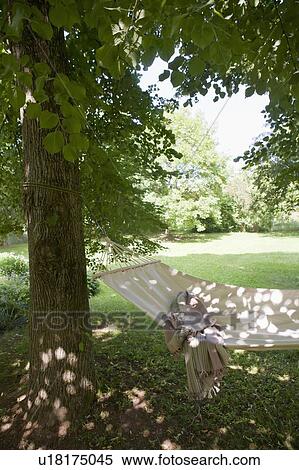 Stock Photography - Blanket in backyard hammock. Fotosearch