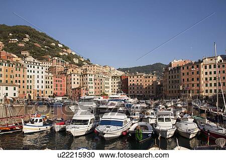 Stock Image - Boats docked in urban pier. Fotosearch