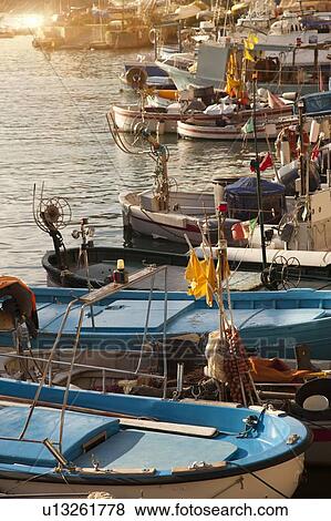 Boats docked in urban pier View Large Photo Image Stock Photo - Boats docked in urban pier. Fotosearch