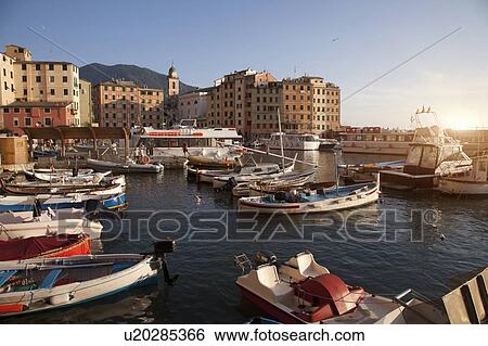 Stock Photograph - Boats docked in urban pier. Fotosearch