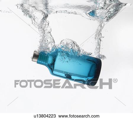 Stock Image - Bottle splashing in water. Fotosearch