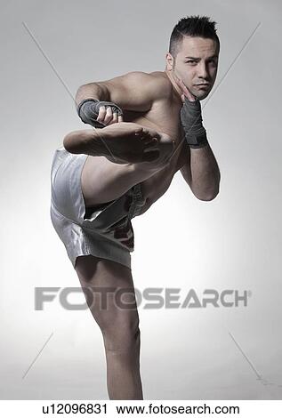 Stock Image - Boxer jabbing and kicking. Fotosearch