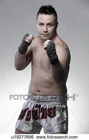 Boxer standing with fists raised View Large Photo Image Stock Photograph - Boxer standing with fists raised. Fotosearch
