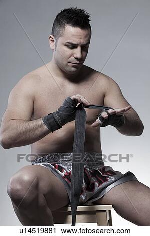 Stock Image - Boxer wrapping his hands. Fotosearch