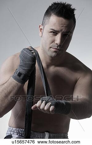 Stock Photograph - Boxer wrapping his hands. Fotosearch