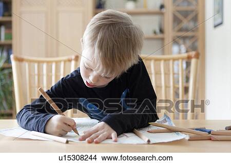 Picture - Boy drawing with colored pencils. Fotosearch