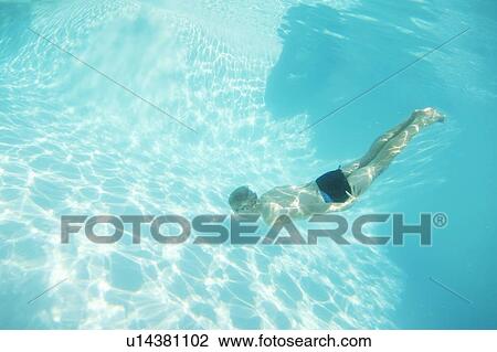 Boy in goggles swimming in pool View Large Photo Image Stock Image - Boy in goggles swimming in pool. Fotosearch