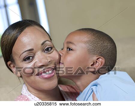 Boy kissing mothers cheek View Large Photo Image Stock Photography - Boy kissing mothers cheek. Fotosearch