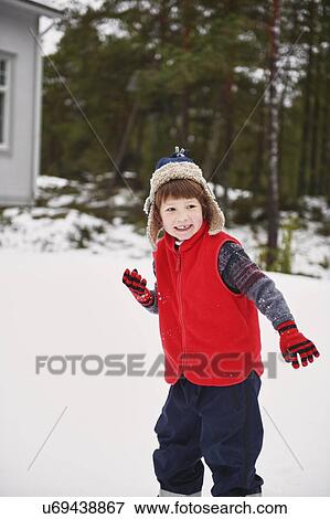 Boy playing in snow outdoors View Large Photo Image Stock Photo - Boy playing in snow outdoors. Fotosearch