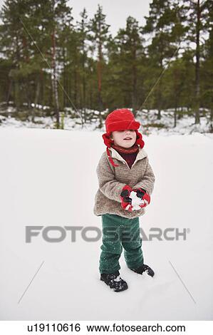 Boy playing in snow outdoors View Large Photo Image Stock Photograph - Boy playing in snow outdoors. Fotosearch