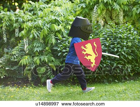 Boy playing with sword in backyard View Large Photo Image Stock Photo - Boy playing with sword in backyard. Fotosearch