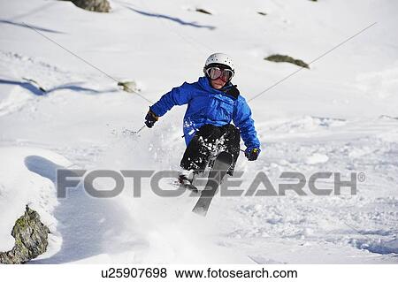Boy skiing on snowy mountainside View Large Photo Image Stock Photo - Boy skiing on snowy mountainside. Fotosearch