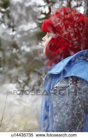 Boy standing at frosty window View Large Photo Image Stock Photography - Boy standing at frosty window. Fotosearch
