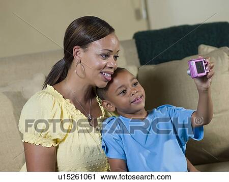 Boy taking picture of himself and mother View Large Photo Image Stock Image - Boy taking picture of himself and mother. Fotosearch