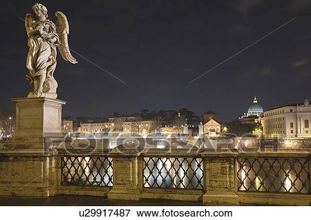 Bridge and statues lit up at night View Large Photo Image Stock Photo - Bridge and statues lit up at night. Fotosearch