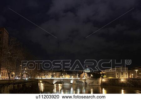 Stock Image - Bridge in the Vatican lit up at night. Fotosearch