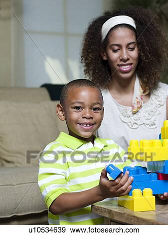Stock Photo - Brother and sister playing with Legos. Fotosearch