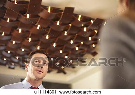 Business people talking in lobby View Large Photo Image Stock Image - Business people talking in lobby. Fotosearch