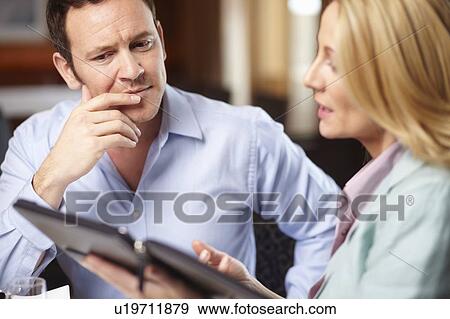 Business people using tablet computer View Large Photo Image Stock Photo - Business people using tablet computer. Fotosearch
