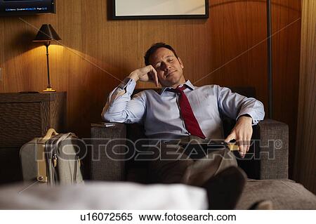 Businessman napping in hotel room View Large Photo Image Stock Photography - Businessman napping in hotel room. Fotosearch