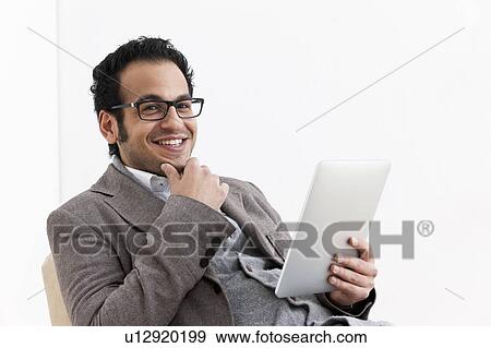 Stock Photo - Businessman using tablet computer. Fotosearch