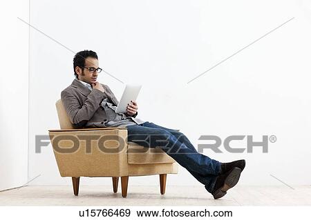 Businessman using tablet computer View Large Photo Image Stock Photo - Businessman using tablet computer. Fotosearch