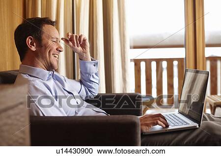 Businesswoman using laptop in hotel room View Large Photo Image Stock Image - Businesswoman using laptop in hotel room. Fotosearch