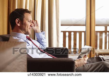 Businesswoman using tablet in hotel room View Large Photo Image Stock Image - Businesswoman using tablet in hotel room. Fotosearch