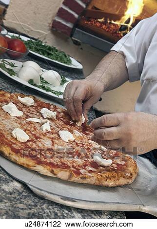 Chef garnishing pizza with cheese View Large Photo Image Stock Image - Chef garnishing pizza with cheese. Fotosearch