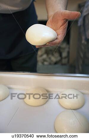 Chef holding pizza dough loaf View Large Photo Image Stock Image - Chef holding pizza dough loaf. Fotosearch