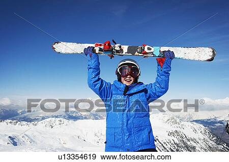 Child holding skis on snowy mountaintop View Large Photo Image Stock Photo - Child holding skis on snowy mountaintop. Fotosearch