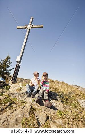 Children sitting under wooden cross View Large Photo Image Stock Image - Children sitting under wooden cross. Fotosearch