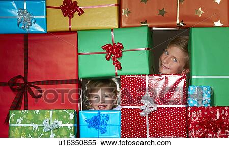 Children smiling in Christmas gift fort View Large Photo Image Stock Photography - Children smiling in Christmas gift fort. Fotosearch