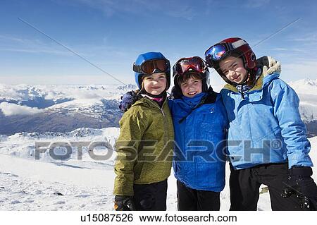 Children standing together in snow View Large Photo Image Stock Photograph - Children standing together in snow. Fotosearch