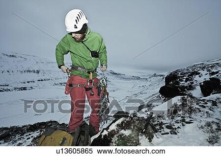 Stock Photography - Climber with carbines on snowy hill. Fotosearch