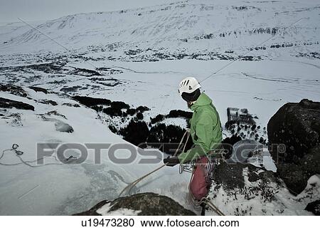 Climber with rope on snowy hill View Large Photo Image Stock Image - Climber with rope on snowy hill. Fotosearch