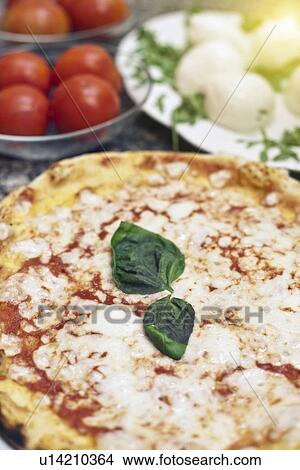 Picture - Close up of basil leaves on pizza. Fotosearch
